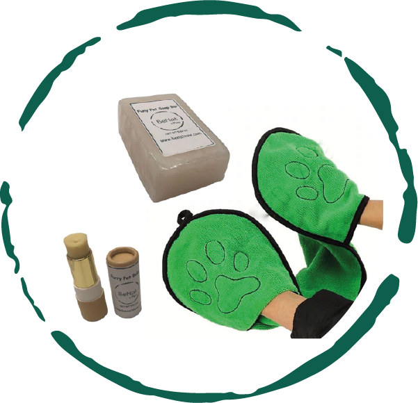 Green pet grooming mitts with a box and bottles on a white background