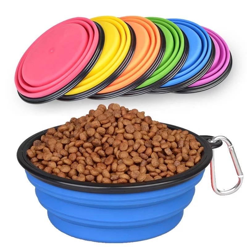 Blue silicone pet bowl with food and colorful lids on a white background